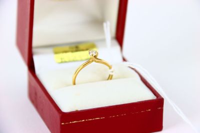 a red box with a gold ring inside of it
