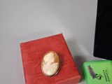 a small box with a ring on it next to other items