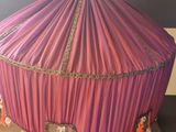 a large pink tent with tassels on top of it