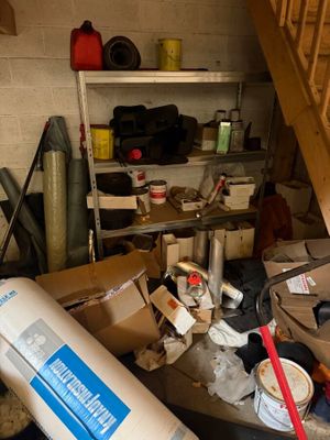 a pile of boxes and other items in a garage
