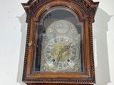 a grandfather clock that is in the corner of a room