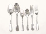 five silver spoons and two silver spoons on a white surface