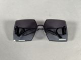 black square sunglasses with black lenses on a white surface