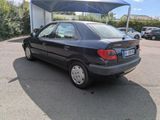 a black car that is parked in a parking lot