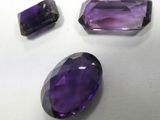 three amethtites of different sizes and colors