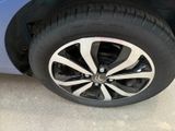 a close up of a tire on a blue car