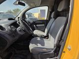 a yellow truck with two seats in the back of it