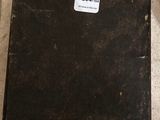 a black suitcase sitting on the floor with a tag on it