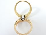 a close up of a gold ring with a diamond in it