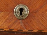 a close up of a wooden cabinet with a keyhole