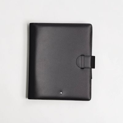 the black leather ipad case is open on a white surface