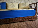 a blue couch with two pillows on it in a room