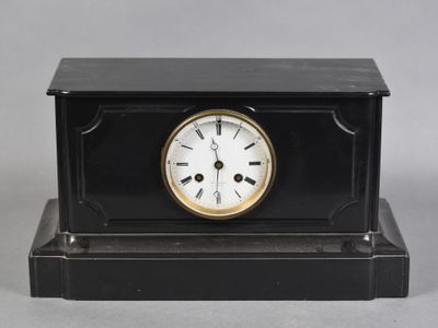 an image of a black and gold clock sitting on top of a table