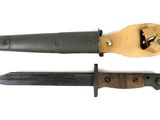 two different types of knives on a white surface