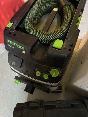 a black and green corded vacuum and a black and green hose