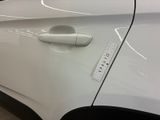 a close up of a car door handle with a sticker on it