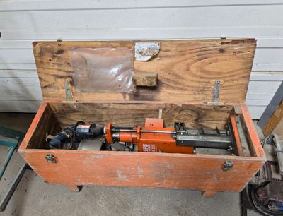 an old tool box with a hammer and other tools in it