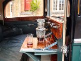 a tray that has a glass on it in the back of a car