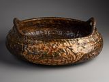 a brown bowl that is sitting on a table
