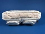 a white pillow that is sitting on a blue surface