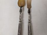 two forks and spoons are sitting on a white surface