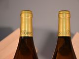 two bottles of wine that are sitting on a table