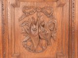 an antique carved wood panel with a bird and flowers on it