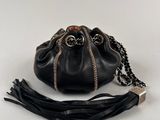 a black purse with a chain around it on a white background