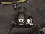 a black camera with a yellow strap on it