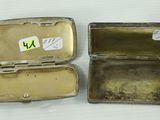a small metal box that has a small piece of gold inside of it