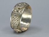 an image of a silver ring with an intricate design on it