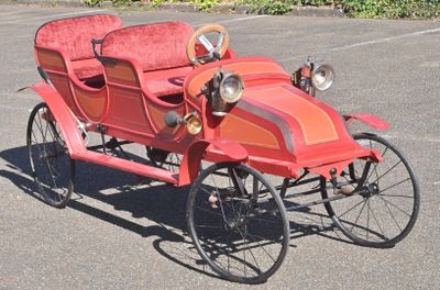 an old fashioned car that is parked in the parking lot