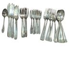 a lot of silver spoons and forks on a white background