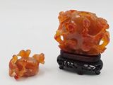 a small piece of orange jade with a small piece of orange jade