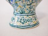 a blue and white vase with writing on it