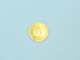 a gold coin sitting on top of a blue surface
