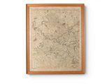 map of the world in a wooden frame on a white wall