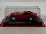 a red car in a glass case on a white surface