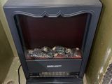 a small black stove in the corner of a room