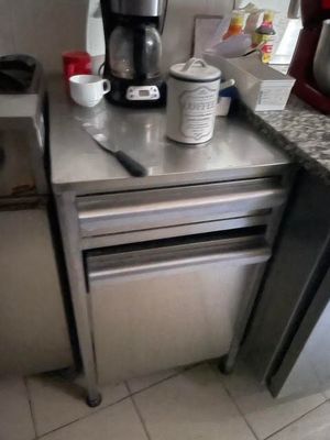 a small kitchen with a coffee maker and a dishwasher