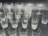 a lot of glasses that are sitting on a table