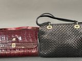 pair of black and red purses on grey background