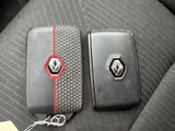 two cell phones that are sitting on the seat of a car