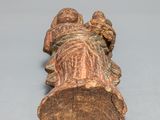 an old wooden figurine of a man laying on his back