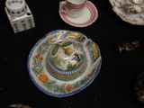 a table with a plate, saucer, cup, and salt shaker