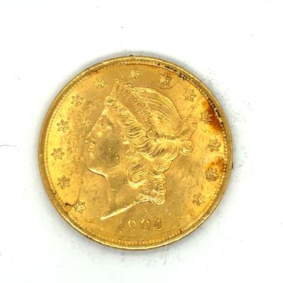 une image d'une pièce d'or sur une surface blanche