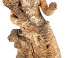 statue of a woman sitting on a rock with a dog