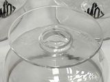 four clear glass bowls sitting on top of a white table