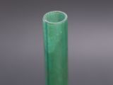 a close up of a green glass tube on a table