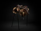 an image of a horse saddle on a stand in the dark